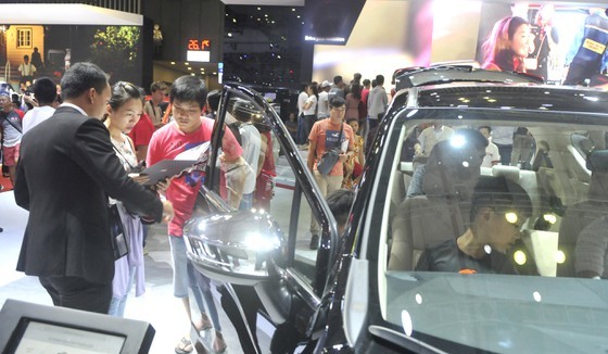 Potential buyers reviewing cars’ specs
