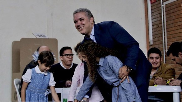 Ứng viên Tổng thống Colombia Ivan Duque (phải) bỏ phiếu tại điểm bầu cử ở Bogota ngày 17/6. (Nguồn: THX/TTXVN)