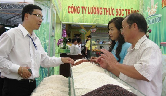 The representative of a rice producer introduces high-quality rice varieties of Soc Trang Province. (Photo: SGGP)