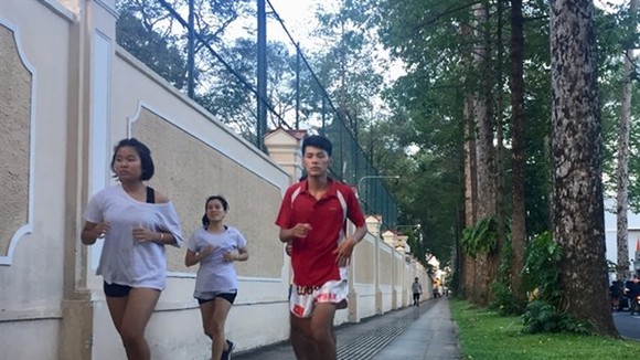 People exercise on pavement near the Independence Palace in HCM City’s District 1. (Photo: VNA)