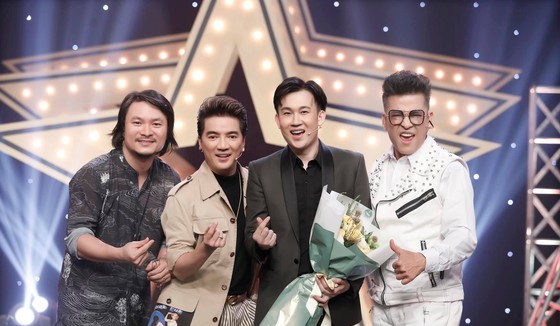 Director Hoang Nhat Nam (L), singers Dam Vinh Hung (2nd, L) and Duong Trieu Vu, MC Thanh Bach (R) join the event.