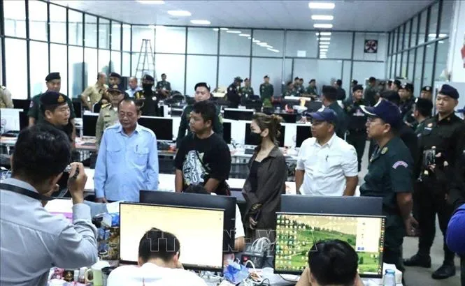 Lực lượng chức năng tỉnh Kratie đột kích một địa điểm tại huyện Snuol được sử dụng làm trung tâm lừa đảo trực tuyến trên địa bàn, bắt giữ trên 300 người nước ngoài vào tháng 7-2025. Ảnh: AKP/TTXVN phát