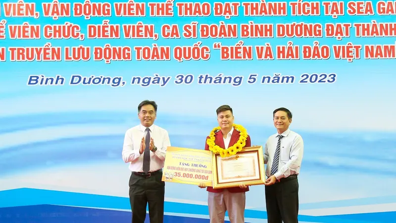 Ông Nguyễn Văn Lộc - Chủ tịch HĐND tỉnh và ông Nguyễn Lộc Hà - Phó Chủ tịch UBND tỉnh Bình Dương thừa ủy quyền của Thủ tướng Chính phủ, trao bằng khen của Thủ tướng và tiền thưởng cho VĐV Lại Lý Huynh