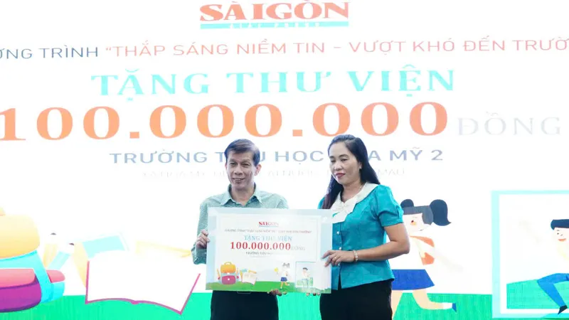 Nhà báo Nguyễn Khắc Văn, Phó Tổng Biên tập Phụ trách Báo Sài Gòn Giải Phóng, trao bảng tượng trưng tặng trang thiết bị thư viện cho đại diện Trường Tiểu học xã Hòa Mỹ (huyện Cái Nước, tỉnh Cà Mau)