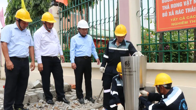Ông Dương Hồng Nhân, Bí thư Đảng ủy SAWACO (thứ hai từ phải sang) trao đổi cùng công nhân trong quá trình lắp đặt trụ nước uống trực tiếp phục vụ người dân