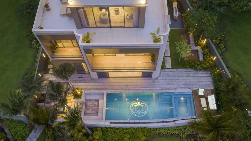 Mặt sau dinh thự nhìn từ trên cao và hồ bơi nổi bật với logo Elie Saab, trong đó gồm khu vực Jacuzzi và BBQ, địa điểm lý tưởng cho những buổi họp mặt của gia chủ và thượng khách