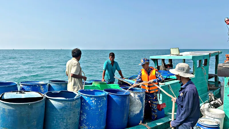 Người dân đảo Hòn Chuối sử dụng thùng phuy vận chuyển nước từ tàu 527 lên đảo