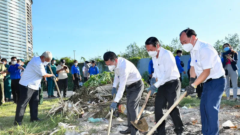 Các đồng chí lãnh đạo quận 7 tham gia dọn vệ sinh môi trường. Ảnh: VIỆT DŨNG