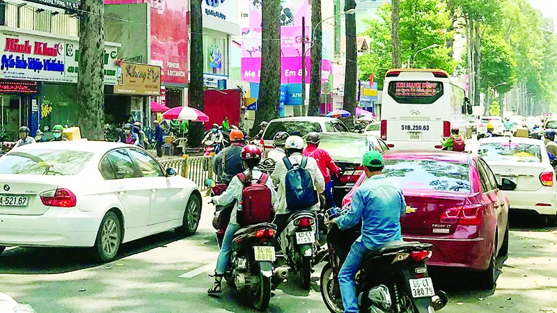  Cổng Bệnh viện Từ Dũ bị lấn chiếm nên các ô tô phải đón khách dưới lòng đường, gây khó khăn cho người tham gia giao thông