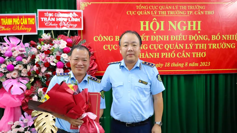 Ông Trần Hữu Linh (phải), Tổng Cục trưởng Cục QLTT, trao quyết định điều động, bổ nhiệm cho ông Nguyễn Hùng Em