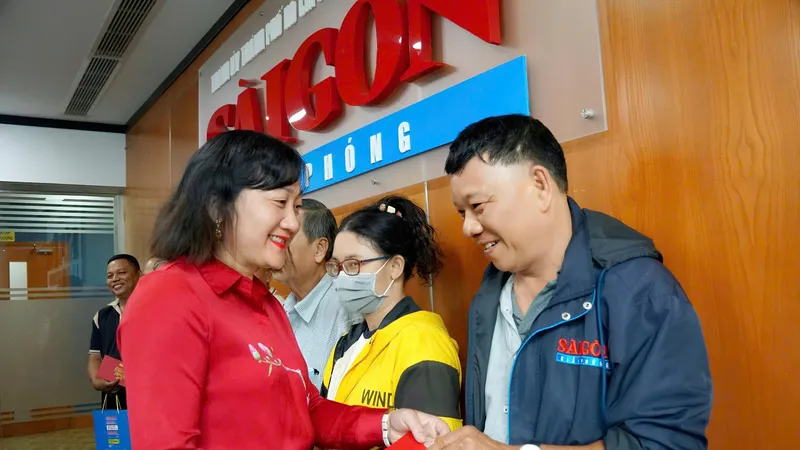 Bà Bùi Thị Hồng Sương, Phó Tổng Biên tập Báo Sài Gòn Giải Phóng trao quà cho cộng tác viên phát hành của báo. Ảnh: VIỆT NGA