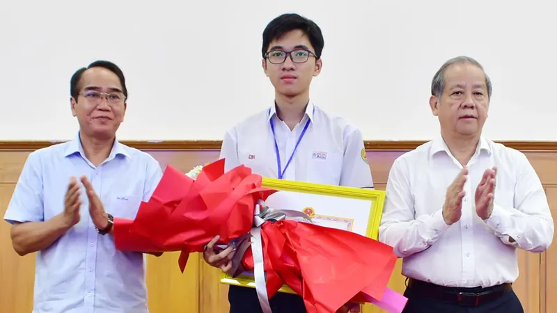 Ông Bùi Thanh Hà, Phó Bí thư Thường trực Tỉnh ủy Thừa Thiên - Huế và ông Phan Ngọc Thọ, Chủ tịch UBND tỉnh trao tặng bằng khen cho học sinh Hồ Việt Đức ​