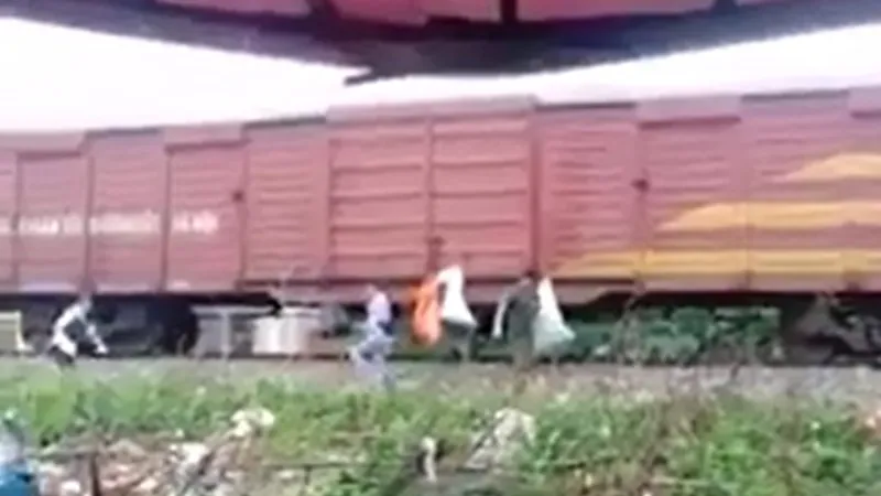 Một số người dân treo các bao rác thải lên thành toa tàu hỏa (Ảnh cắt từ clip trên facebook)