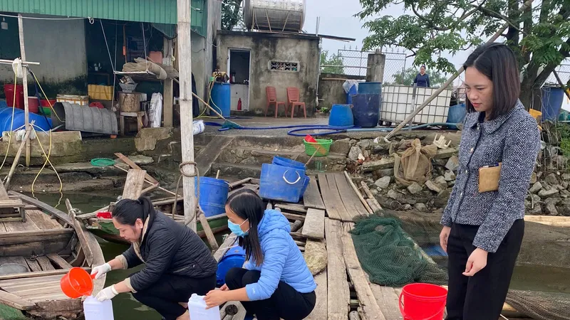 Cơ quan chức năng tiến hành lấy mẫu nước tại hồ nuôi có cá chim chết để gửi đi phân tích 