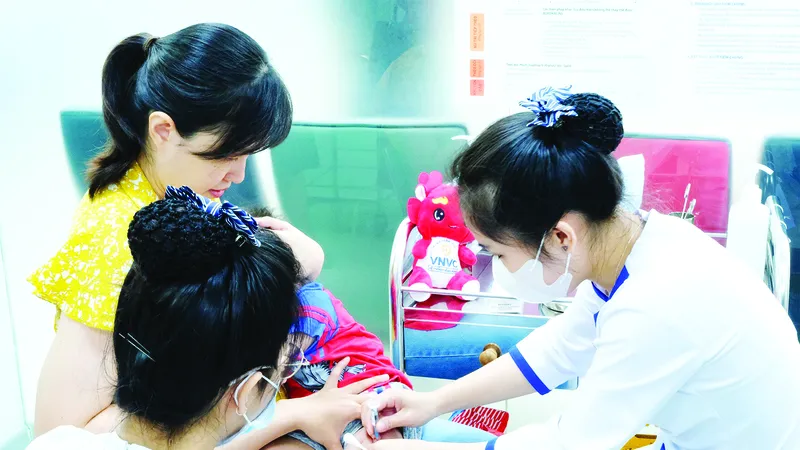Nhân viên y tế tại một trung tâm tiêm chủng tiêm vaccine cho trẻ
