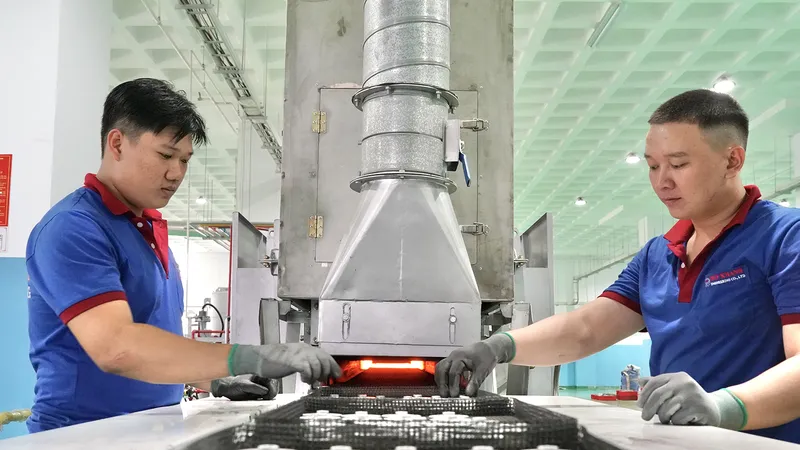Sản phẩm từ ép bột kim loại của Công ty TNHH Cơ khí Duy Khanh đang được đưa vào dây chuyền gia nhiệt. Ảnh: HOÀNG HÙNG