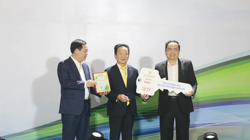 Doanh nhân Đỗ Quang Hiển (ở giữa) trao ủng hộ, đồng hành cùng chương trình “Cả nước chung tay vì người nghèo” năm 2019