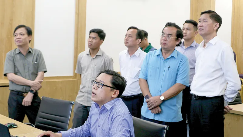 Phó Chủ tịch UBND TPHCM Trần Vĩnh Tuyến cùng Chủ tịch UBND tỉnh Bạc Liêu Dương Thành Trung theo dõi các mô hình quản lý đô thị thông minh tại TPHCM. Ảnh: HOÀNG HÙNG