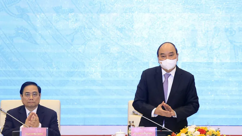 Chủ tịch nước Nguyễn Xuân Phúc và Thủ tướng Phạm Minh Chính tại Hội thảo “Những vấn đề lý luận và thực tiễn về Nhà nước pháp quyền xã hội chủ nghĩa”. Ảnh: TTXVN 