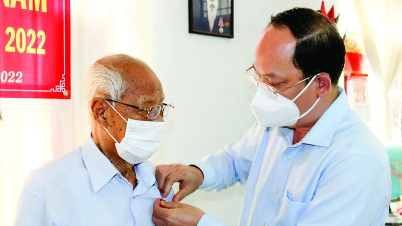 Phó Bí thư Thành ủy TPHCM Nguyễn Hồ Hải trao Huy hiệu 75 năm tuổi Đảng cho đồng chí Nguyễn Văn Hanh. Ảnh: DŨNG PHƯƠNG