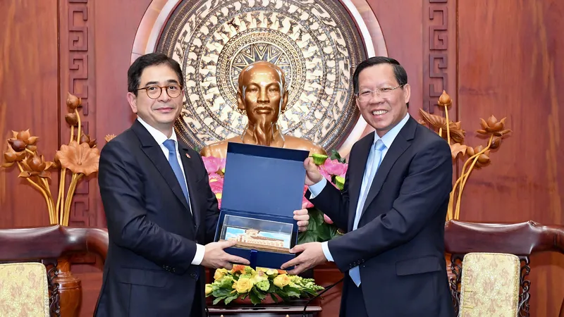 Chủ tịch UBND TPHCM Phan Văn Mãi tặng quà lưu niệm Chủ tịch Phòng Thương mại - Công nghiệp Indonesia Arsjad Rasjid. Ảnh: VIỆT DŨNG