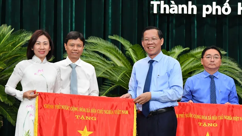 Chủ tịch UBND TPHCM Phan Văn Mãi trao cờ thi đua cho đơn vị xuất sắc. Ảnh: VIỆT DŨNG