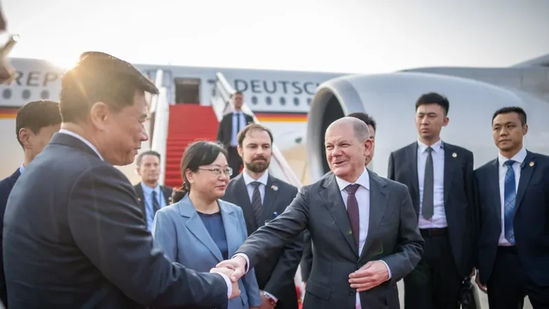 Thủ tướng Đức Olaf Scholz (phải) đang bắt tay với một quan chức Trung Quốc khi đến TP Trùng Khánh (Trung Quốc) hôm 14-4. Ảnh: BLOOMBERG