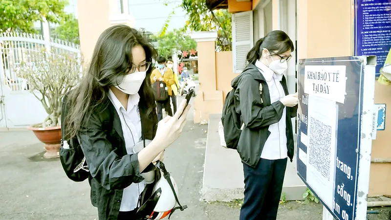 Học sinh Trường THPT chuyên Lê Hồng Phong khai báo y tế trước khi vào trường. Ảnh: CAO THĂNG