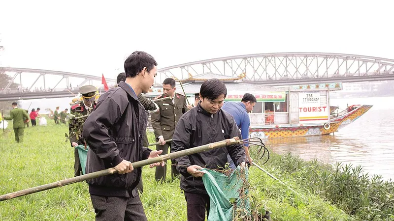  Công an tỉnh Thừa Thiên- Huế cùng sinh viên dọn rác và vớt bèo dọc bờ sông Hương