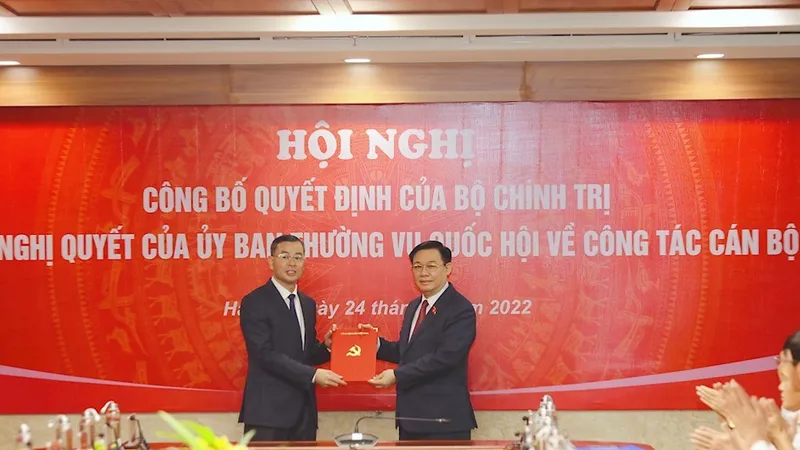 Chủ tịch Quốc hội Vương Đình Huệ trao quyết định và chúc mừng đồng chí Ngô Văn Tuấn. Ảnh: www.hcmcpv.org.vn