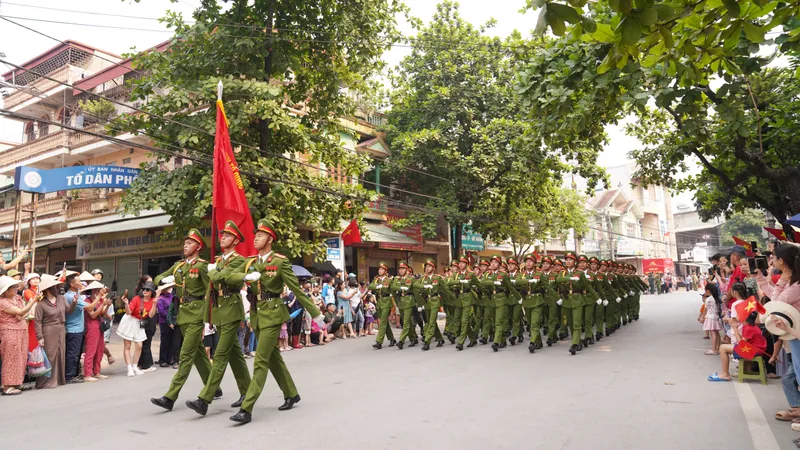 Người dân bên đường vẫy cờ đón đoàn diễu binh tổng duyệt 70 năm Chiến thắng Điện Biên Phủ