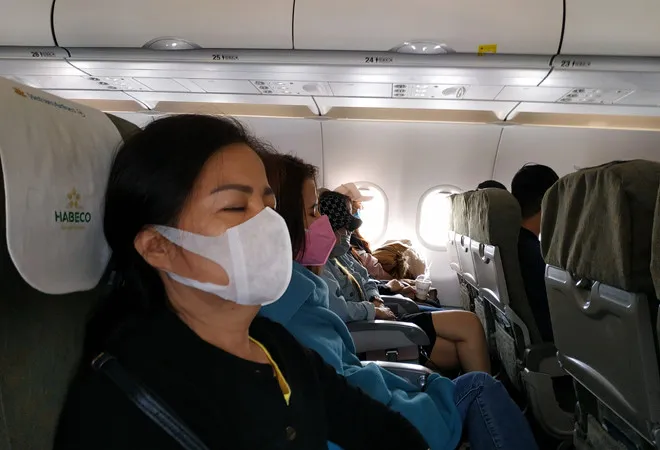 Hành khách đeo khẩu trang trên máy bay