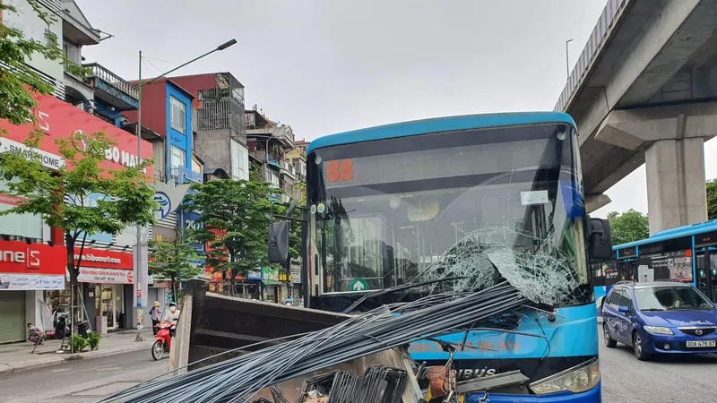 Xe ba gác chở nhiều thanh sắt xuyên thủng kính xe buýt