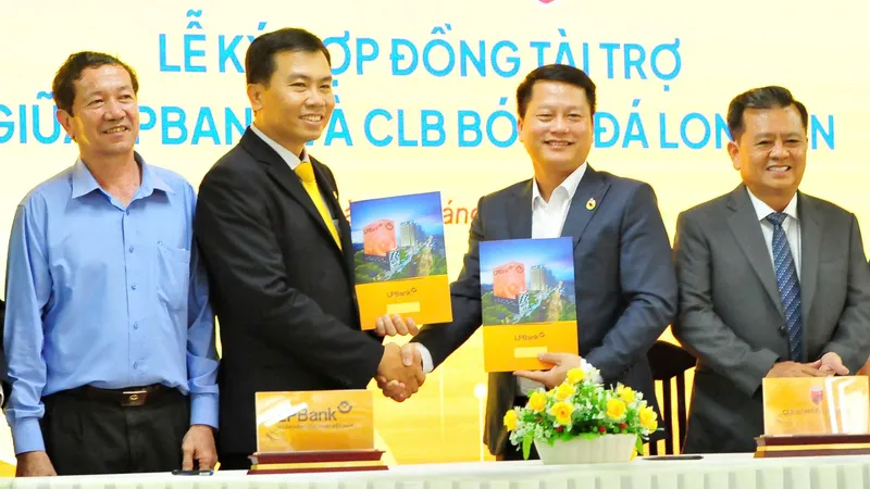 Ông Nguyễn Minh Tâm, Giám đốc Công ty CP Thể thao Long An (thứ hai từ phải sang) bắt tay cùng ông Phạm Ngọc Thủy, Giám đốc LPBank chi nhánh Long An tại lễ ký hợp đồng. Ảnh: ANH TUẤN 