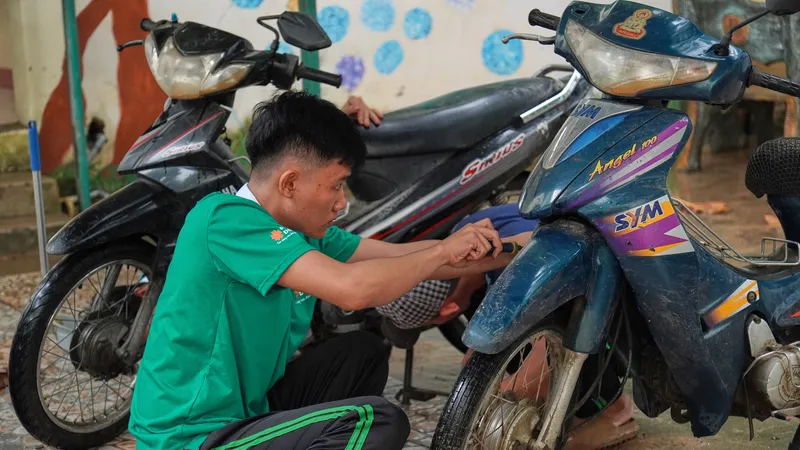 Sinh viên Đại học Đông Á sửa xe máy ngập nước tại THPT Chu Văn An