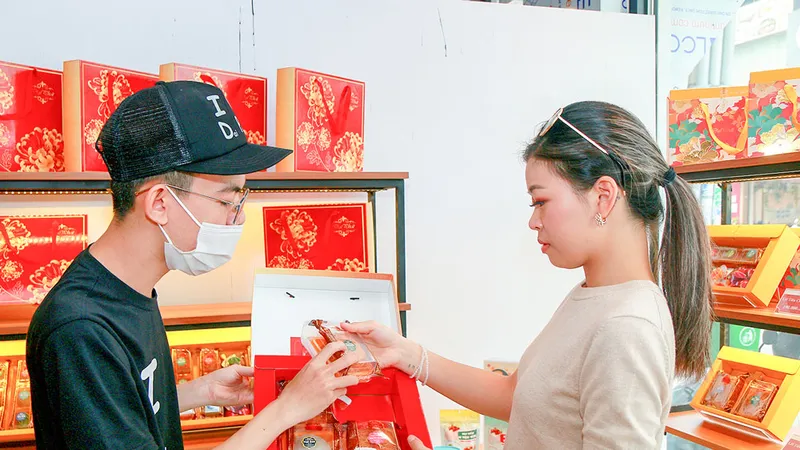 Tư vấn khách hàng chọn mua bánh trung thu. Ảnh: NGUYỄN PHAN