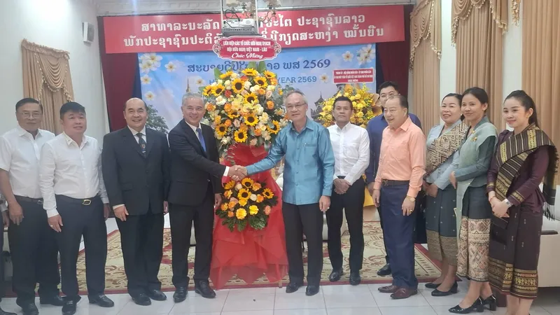 Chủ tịch Hội Hữu nghị Việt Nam - Lào TPHCM Ngô Minh Châu và thành viên trong đoàn tặng hoa, chúc mừng năm mới cán bộ, nhân viên Tổng Lãnh sự quán Lào tại TPHCM