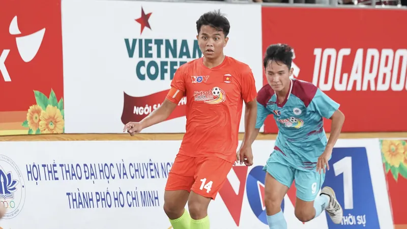 Trận đấu khai mạc giữa 2 đội futsal đến từ Trường Đại học Nông Lâm (áo cam) và Trường Đại học Ngoại ngữ - Tin học (áo xanh). ẢNH: TÂM HÀ