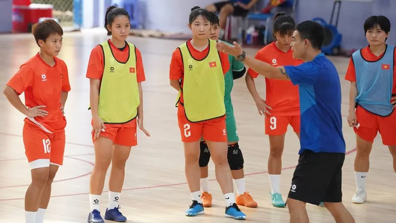 HLV Nguyễn Đình Hoàng cùng các nữ tuyển thủ futsal Việt Nam quyết tâm hướng đến tấm huy chương vàng SEA Games 33. ẢNH: QUỐC KHANH 