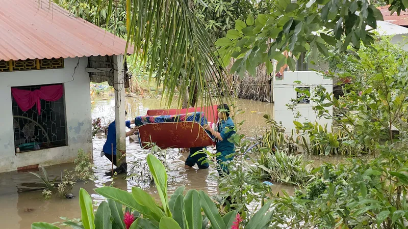 Lượng lượng chức năng giúp người dân di chuyển đồ ra khỏi căn nhà bị ngập