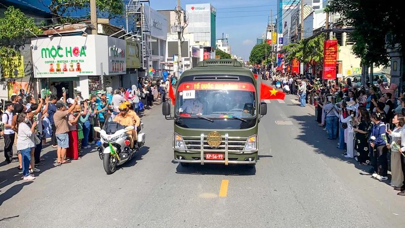 车队途经各条道路，沿途众多民众怀着崇敬与感恩之情，向烈士致以深切哀悼。图片：孟胜