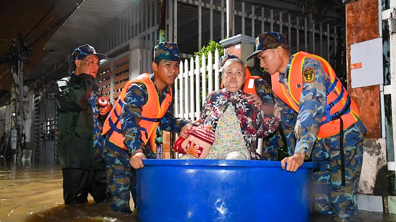Cán bộ, chiến sĩ hỗ trợ người cao tuổi di dời ra khỏi vùng ngập sâu. Ảnh: LỮ ĐOÀN 681
