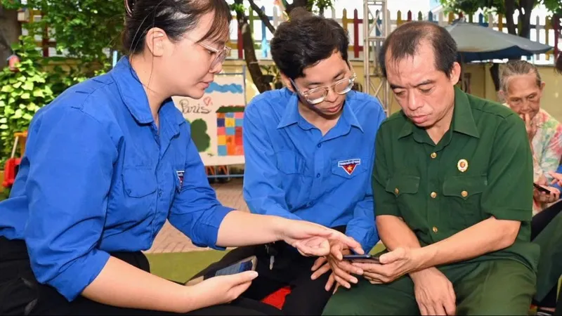 Các tình nguyện viên trẻ hướng dẫn người dân cài đặt, đăng nhập VNeID