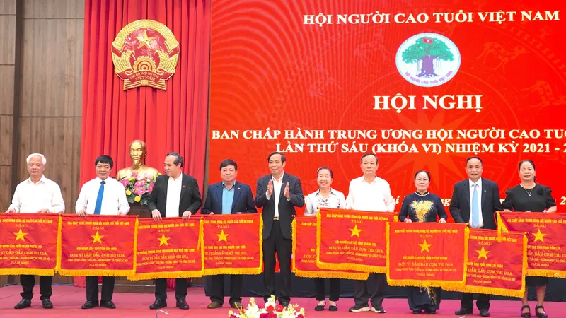 Ông Nguyễn Thanh Bình, Chủ tịch Hội Người cao tuổi Việt Nam trao cờ thi đua cho các tập thể. QUANG HUY