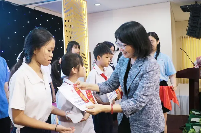 Vice Chairwoman of the Ho Chi Minh City People’s Committee Tran Thi Dieu Thuy offers scholarships to students. (Photo: SGGP)