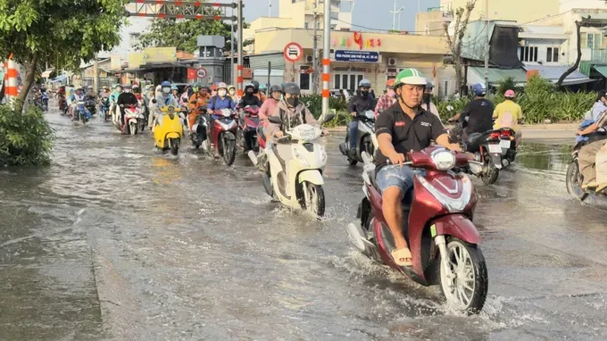Vehicles travel through a flooded section of Tran Xuan Soan Street in Ho Chi Minh City on the afternoon of September 28. (Photo: SGGP)