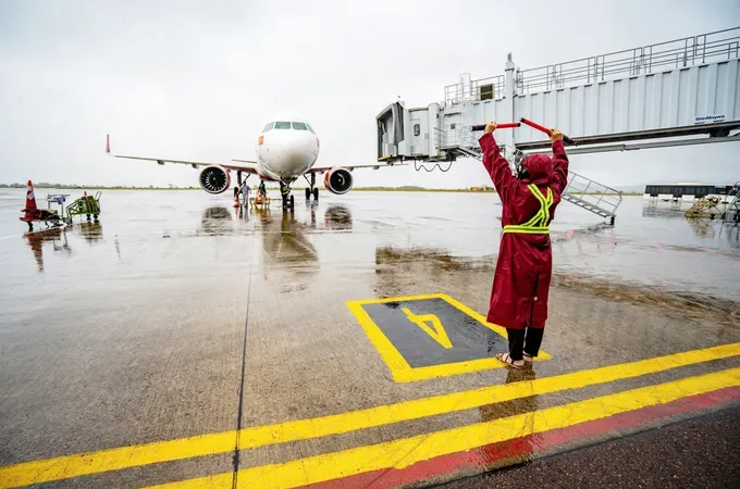 A technician controls and guides an aircraft at Phu Cat Airport.