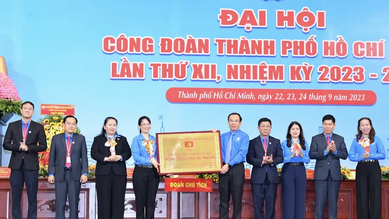 Bí thư Thành ủy TPHCM Nguyễn Văn Nên trao tặng Bảng đồng với dòng chữ Công đoàn TPHCM Đổi mới – Dân chủ – Đoàn kết – Phát triển đến đại hội. Ảnh: VIỆT DŨNG.