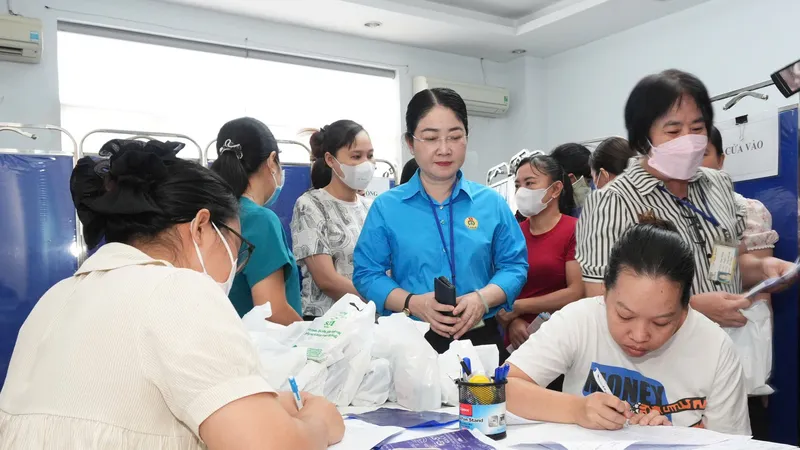 Nữ công nhân điền thông tin để được kiểm tra sức khỏe, tầm soát ung thư tại chương trình