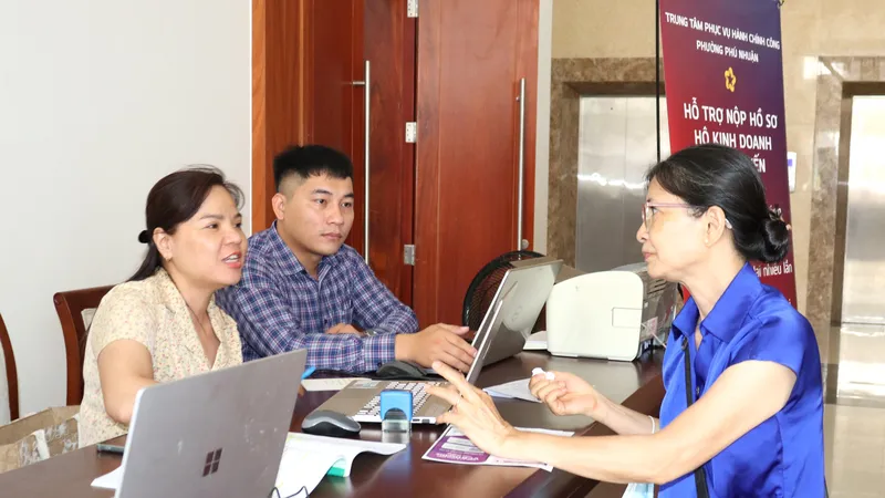 Tư vấn người dân đăng ký hộ kinh doanh tại ngày hội. Ảnh: THÁI PHƯƠNG